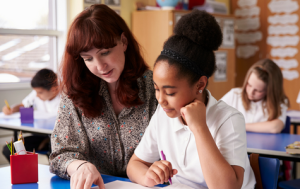 Teacher helping student with her work