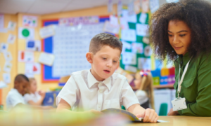 A teaching who has her Level 5 diploma in specialist teaching helping a boy